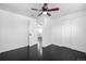 Inviting bedroom with a ceiling fan, spacious closet, and access to additional rooms at 7977 Durango St, Denver, CO 80221