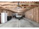 Spacious garage featuring natural wood frame and an unfinished ceiling, ready for your custom storage at 7977 Durango St, Denver, CO 80221