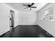 Open-concept living room featuring modern ceiling fan, hardwood floors, and natural light at 7977 Durango St, Denver, CO 80221