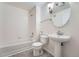 Clean bathroom with pedestal sink and bathtub at 3875 S Dayton St # 107, Aurora, CO 80014