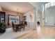 Traditional dining room featuring hardwood floors, large windows and a wooden table with seating for six at 7033 S Versailles St, Aurora, CO 80016