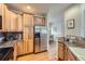 Spacious kitchen featuring wood cabinetry, stainless steel appliances, granite countertops and hardwood floors at 7033 S Versailles St, Aurora, CO 80016