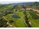 Beautiful aerial view of golf course with a lake and the scenic mountain range in the background at 6268 Dakota Ridge Dr, Littleton, CO 80125