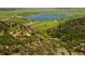Elevated view of rolling hills, lake, and rugged natural landscape features in a rural location at 6268 Dakota Ridge Dr, Littleton, CO 80125