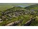 Stunning aerial view of a residential area surrounded by green hills and a tranquil lake at 6268 Dakota Ridge Dr, Littleton, CO 80125