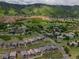 Neighborhood aerial view showcasing expansive homes and mature trees, nestled next to a dramatic ridgeline at 6268 Dakota Ridge Dr, Littleton, CO 80125