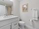Modern bathroom with light gray walls, a shower with a curtain, and white cabinets at 6268 Dakota Ridge Dr, Littleton, CO 80125