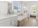 Elegant bathroom featuring a soaking tub, double vanity sinks, and stylish tile flooring at 6268 Dakota Ridge Dr, Littleton, CO 80125
