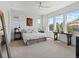 Bright bedroom with large windows offering scenic views, ceiling fan, and neutral decor at 6268 Dakota Ridge Dr, Littleton, CO 80125