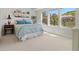 Bright bedroom with a large window, light blue bedding, and mountain views at 6268 Dakota Ridge Dr, Littleton, CO 80125