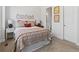 Cozy bedroom featuring floral bedding, decorative wall art, and an en-suite bathroom at 6268 Dakota Ridge Dr, Littleton, CO 80125