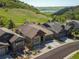 Beautiful neighborhood home showcasing mature landscaping and a serene backdrop of mountains and a lake at 6268 Dakota Ridge Dr, Littleton, CO 80125