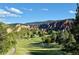 Beautiful golf course surrounded by mountains and mature trees at 6268 Dakota Ridge Dr, Littleton, CO 80125
