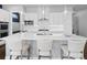 Bright kitchen featuring white cabinets, a large island with seating, and stainless steel appliances for a modern look at 6268 Dakota Ridge Dr, Littleton, CO 80125