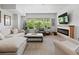 Bright living room with large windows, comfortable seating, and electric fireplace at 6268 Dakota Ridge Dr, Littleton, CO 80125