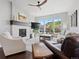Bright living room with a cozy fireplace, large windows offering scenic views, and stylish modern furnishings at 6268 Dakota Ridge Dr, Littleton, CO 80125