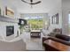 Bright living room with a cozy fireplace, large windows offering scenic views, and stylish modern furnishings at 6268 Dakota Ridge Dr, Littleton, CO 80125