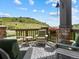 Inviting outdoor patio with comfortable seating and stunning views of the surrounding landscape and hills in the background at 6268 Dakota Ridge Dr, Littleton, CO 80125
