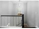 Staircase with white railings, dark banister, modern light fixture, and artwork at 6268 Dakota Ridge Dr, Littleton, CO 80125