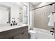 Modern bathroom with sleek vanity, tub shower, and elegant tile accents at 1250 W Osceola St # 2, Denver, CO 80204