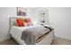 Cozy bedroom with a comfortable bed, soft lighting, and a desert-themed picture at 1250 W Osceola St # 2, Denver, CO 80204