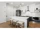 Modern kitchen with stainless steel appliances, white countertops, and a kitchen island with seating at 1250 W Osceola St # 2, Denver, CO 80204