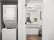 Convenient laundry area with a washer/dryer unit and a nearby bathroom with modern vanity at 1250 W Osceola St # 2, Denver, CO 80204