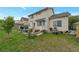 Spacious backyard with lush lawn, landscaping, and a patio area, ideal for outdoor living at 2246 S Ensenada St, Aurora, CO 80013