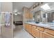 Bright bathroom featuring double vanity and a doorway to a bedroom at 2246 S Ensenada St, Aurora, CO 80013