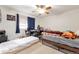 Bedroom featuring a ceiling fan, window, and carpeted floors at 2246 S Ensenada St, Aurora, CO 80013