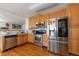 Modern kitchen with wooden cabinets and stainless steel appliances at 2246 S Ensenada St, Aurora, CO 80013