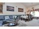 Inviting living room featuring a comfortable gray sofa and a large painting, perfect for relaxation at 2246 S Ensenada St, Aurora, CO 80013