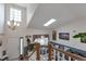 Inviting living room with vaulted ceilings, skylight, an aquarium, and staircase at 2246 S Ensenada St, Aurora, CO 80013