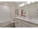Clean bathroom features double sinks, ample counter space, and tub with tiled surround at 4732 Windmill Dr, Brighton, CO 80601