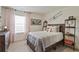 Stylish bedroom features a comfortable bed, modern decor, and ample natural light for a relaxing retreat at 4732 Windmill Dr, Brighton, CO 80601