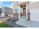Welcoming front entrance with stone accents, covered porch, and manicured landscaping at 4732 Windmill Dr, Brighton, CO 80601