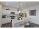 Bright kitchen featuring stainless steel appliances, a granite countertop island, and wood floors at 4732 Windmill Dr, Brighton, CO 80601