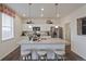 Bright kitchen featuring stainless steel appliances, a granite countertop island, and wood floors at 4732 Windmill Dr, Brighton, CO 80601