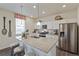 Bright kitchen featuring stainless steel appliances, a granite countertop island, and wood floors at 4732 Windmill Dr, Brighton, CO 80601
