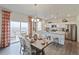 Modern kitchen with granite countertops, stainless steel appliances, and an adjacent dining area at 4732 Windmill Dr, Brighton, CO 80601