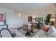 Cozy living room featuring a sectional sofa, modern decor, and an open staircase at 4732 Windmill Dr, Brighton, CO 80601