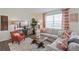 Stylish living room featuring a comfortable sofa, modern decor, and a media center at 4732 Windmill Dr, Brighton, CO 80601