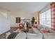 Comfortable living room showcasing a sectional sofa, modern decor, and large windows at 4732 Windmill Dr, Brighton, CO 80601