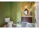Charming powder room with decorative mirror, earth tone finishes, and tiled accent wall at 91 S Sherman St, Denver, CO 80209