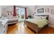Bright bedroom with a crib, bed, large window, and hardwood flooring at 91 S Sherman St, Denver, CO 80209