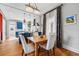 Stylish dining area featuring a wooden table, chic lighting, and an open layout with seamless kitchen access at 91 S Sherman St, Denver, CO 80209
