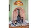 A brick fireplace is complemented by decorative tiles, an ornate wood-burning stove, and an ornamental fan at 91 S Sherman St, Denver, CO 80209