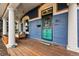 Charming front porch featuring a porch swing, wooden deck, and decorative front door at 91 S Sherman St, Denver, CO 80209