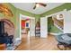 An open-concept living room featuring hardwood floors, a charming fireplace, and access to the kitchen and staircase at 91 S Sherman St, Denver, CO 80209