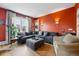 Spacious living room with hardwood floors, large sectional sofa, ottoman, and abundant natural light at 91 S Sherman St, Denver, CO 80209